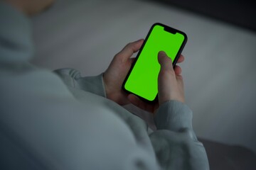 Phone in hand with green background.
Phone close-up with green screen.
chromakey