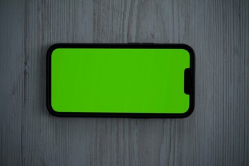 mobile phone with green screen, phone close-up, green screen for background replacement