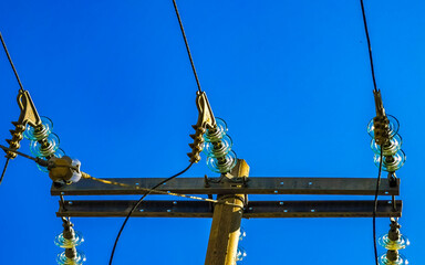 Power pole cable box with blue sky in Mexico.