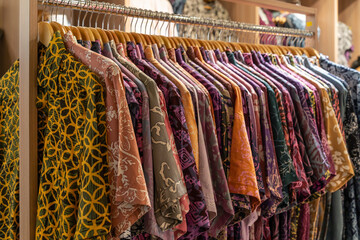 Various types of batik shirts for sale in the retail shop.