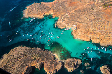 An aerial view of the crystal clear, turquoise coloured waters of the Blue Lagoon, in Comino, one...