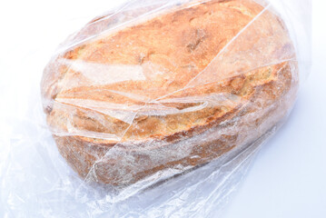 A fresh loaf of bread in a cellophane bag.