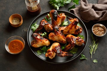 Bbq chicken wings on dark stone background. Close up view