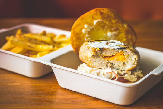 Cheese Stuffed Pork Burger with Cheesy stuffed patty and served with coleslaw and french fries.