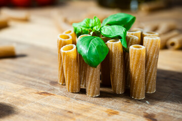macaroni raw pasta Italian food close up macro  with basil 