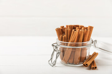Cinnamon sticks on a textured wooden background. Cinnamon roll. Spicy spice for baking, desserts and drinks. Fragrant ground cinnamon. cinnamon powder Close-up. Place for text. copy space