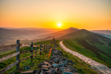 Stone footpath and wooden fence leading a long The Great Ridge in the English Peak District - 778287697