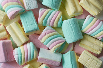 marshmallows close-up, colorful fluffy soft sugar confectionery different shapes and sizes, pile of...
