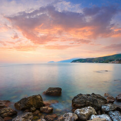 sea bay with stony coast at the twilight