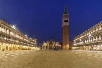 An empty illuminated San Marco square with the bell tower and the cathedral at blue hour on a winter evening, Venice, Veneto, Italy