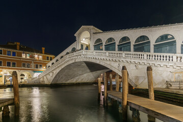 Fototapeta na wymiar Nightscape of illuminated Rialto Bridge over the Canal Grande in winter time, Venice, Veneto, Italy