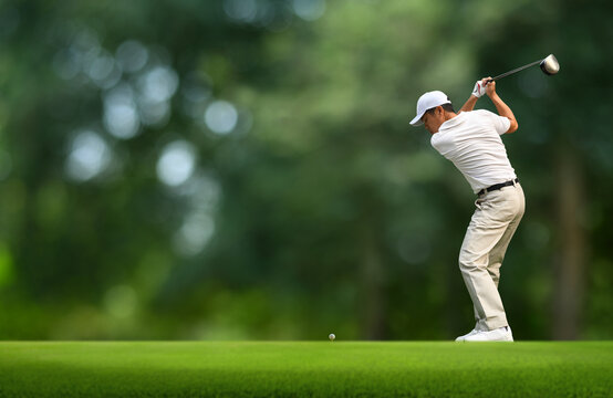 Front view of Golfer driver back swing before hitting golf ball down the fairway. - Powered by Adobe