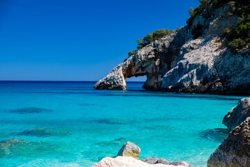 Cala Goloritzé, an azure beach located in the town of Baunei, in the southern part of the Gulf of Orosei, in the Ogliastra region of Sardinia. - obrazy, fototapety, plakaty