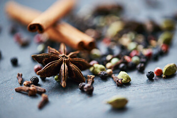 Closeup of whole spices, mix of ingredients and cooking for food, fragrance and flavor with culinary background. Stick cinnamon, star anise and peppercorn for catering, seasoning collection and aroma
