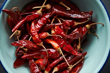 Kissenbezug Above, chilli and bowl on closeup for pepper or spice for flavor and dry ingredient for cooking, cuisine and food. Paprika, cayenne or condiment or spicy with red for capsicum or heat in dish or meal © peopleimages.com