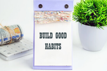 BUILD GOOD HABITS motivational concept text on a piece of a desktop calendar with tear-off pages