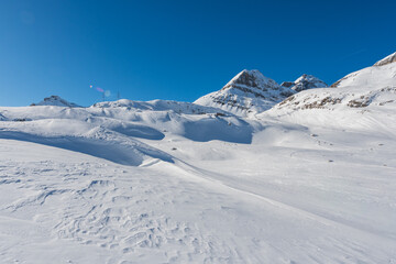 Fototapeta premium Winter hikes in Switzerland are always a good opportunity to see the beauty of the snowy mountains