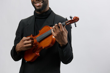 Talented African American musician playing the violin with passion and skill on a white background