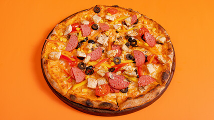 Chicken and sausage pizza isolated on orange background