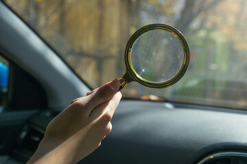 Female hand showing magnifying glass.