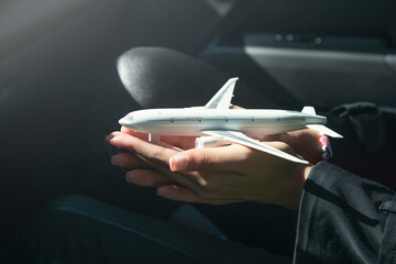 Woman hand showing toy airplane. Travel