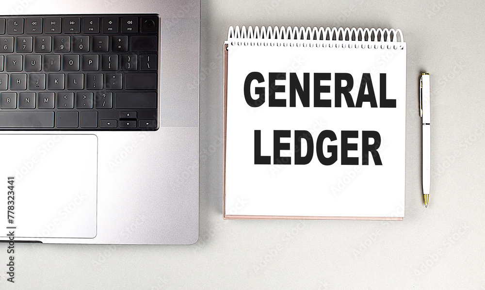 Poster general ledger text on notebook with laptop and pen