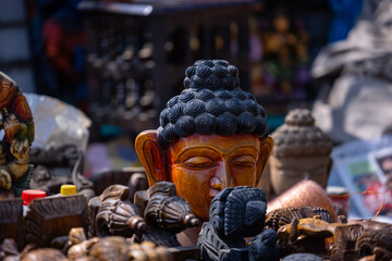 A handmade wooden idol of Lord Buddha sounds like a beautiful tribute to the deity's revered presence in Hindu mythology and culture.  - obrazy, fototapety, plakaty