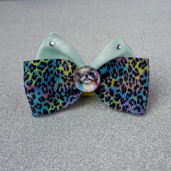 on a golden background there is a pink leopard bow decorated with shiny stones and an insert with a...