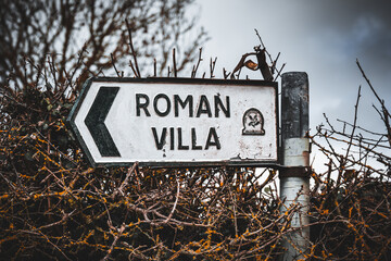 old, damaged metal sign post