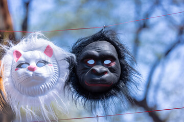 Handmade mask of monkey and cat animal mask hanging at fair. Selective focus.