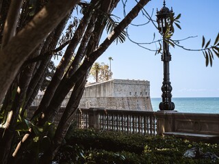 City walls with the bastion Baluarte de la Candelaria and the park of Alameda Apodaca in the Old...