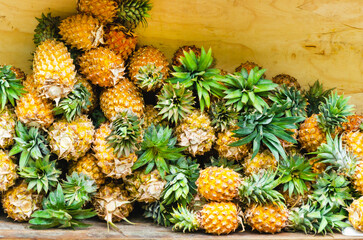 pile of ripe pineapples on street market stall