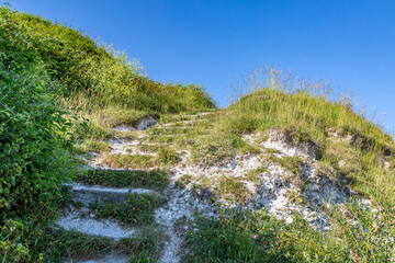 Fototapeta na wymiar Steps in a Sussex hillside with a blue sky overhead