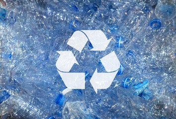 Obraz premium Recycle symbol on used plastic bottles background. Conservation ecological, natural friendly, world waste management. Horizontal seamless background.