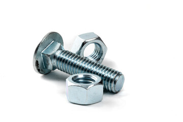 A bright steel or stainless steel hex carriage bolt and hex nuts isolated on white
