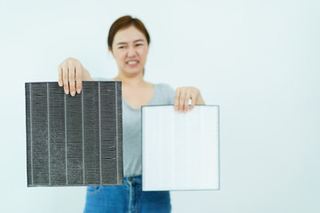 Woman changing air purifier filter.