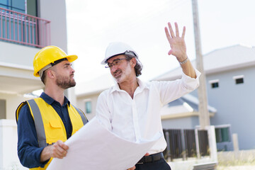 Foreman and client discuss on a building plan and construction.