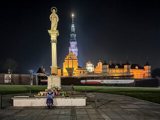 Jasna Gora Monastery and the column with the Blessed Virgin Mary in Czestochowa at night. The inscription on the banner in Polish "Jesus meets his mother"
