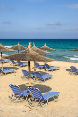 Sunbeds with umbrella on sandy beach of Marmari. The Greek island of Kos