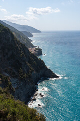 view to one of Cinque Terre towns Vernazza and mountainous coastline seen from a hiking trail from Monterosso al Mare