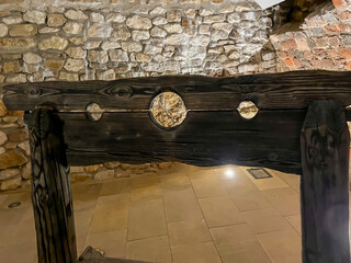 Old stocks - an instrument of torture located in the ruins of the Rabsztyn castle near Olkusz in Poland - 778351203