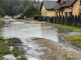 Lack of water drainage causes large puddles to form during rain on small-town streets - 778352021