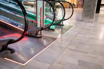 detail of escalator access in a shopping mall. Ascent and descent. Access lights in green, exit...