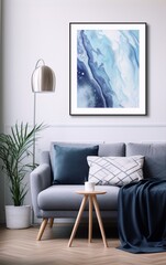 Blue and white abstract painting in a modern living room interior with a gray sofa, a white coffee table, a silver floor lamp and a potted plant