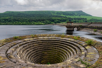 Ladywell reservoir and the overflow drain, nicknamed the plughole. Derwent edge can be seen in the...