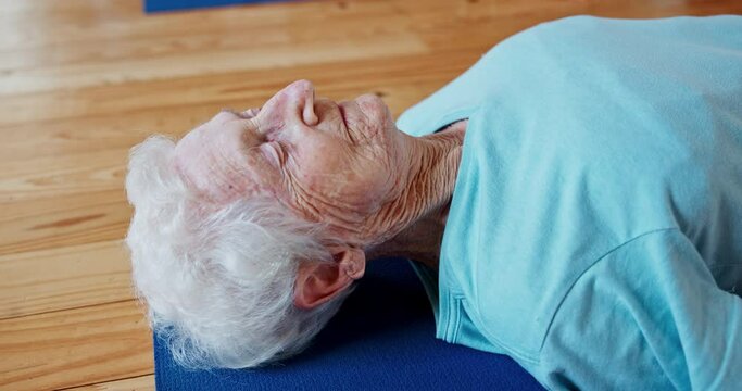 Meditation, yoga and woman in corpse pose at gym to relax for peace, mindfulness or rest for health. Zen, calm and senior person in savasana body exercise on floor for fitness, breathing or wellness