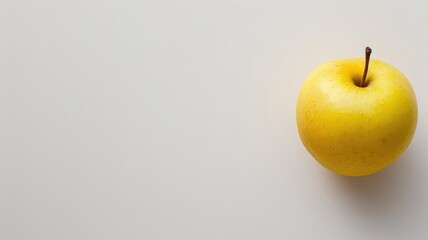 Single yellow apple on a white background.