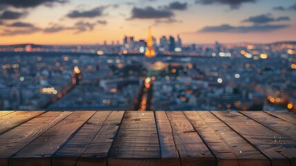 Blurred city view with wooden plank foreground - This image portrays a soft focus city vista at dusk with dewy wooden planks in the foreground, providing depth and context - obrazy, fototapety, plakaty