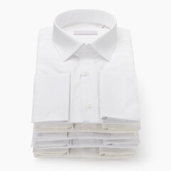 Five white classic folded men's shirts with long sleeves and cufflinks on a light background