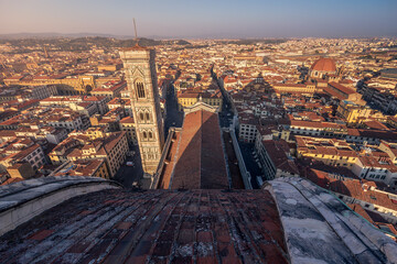 Bell tower of Cattedrale di Santa Maria del Fiore and tiled roofs of medieval city, Florence, Italy - obrazy, fototapety, plakaty